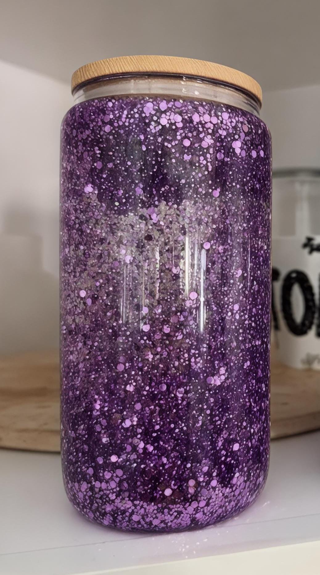 16oz Purple Sparkle Glass Tumbler with bamboo lid in white kitchen cabinet