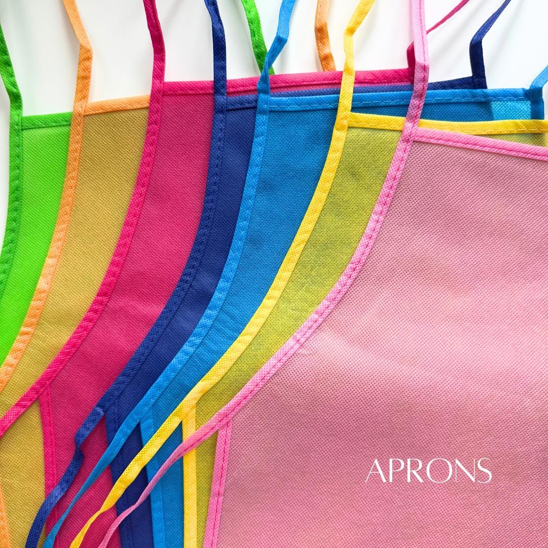 GREEN APRON ORANGE APRON PINK APRON BLUE APRON YELLOW APRON PINK APRON