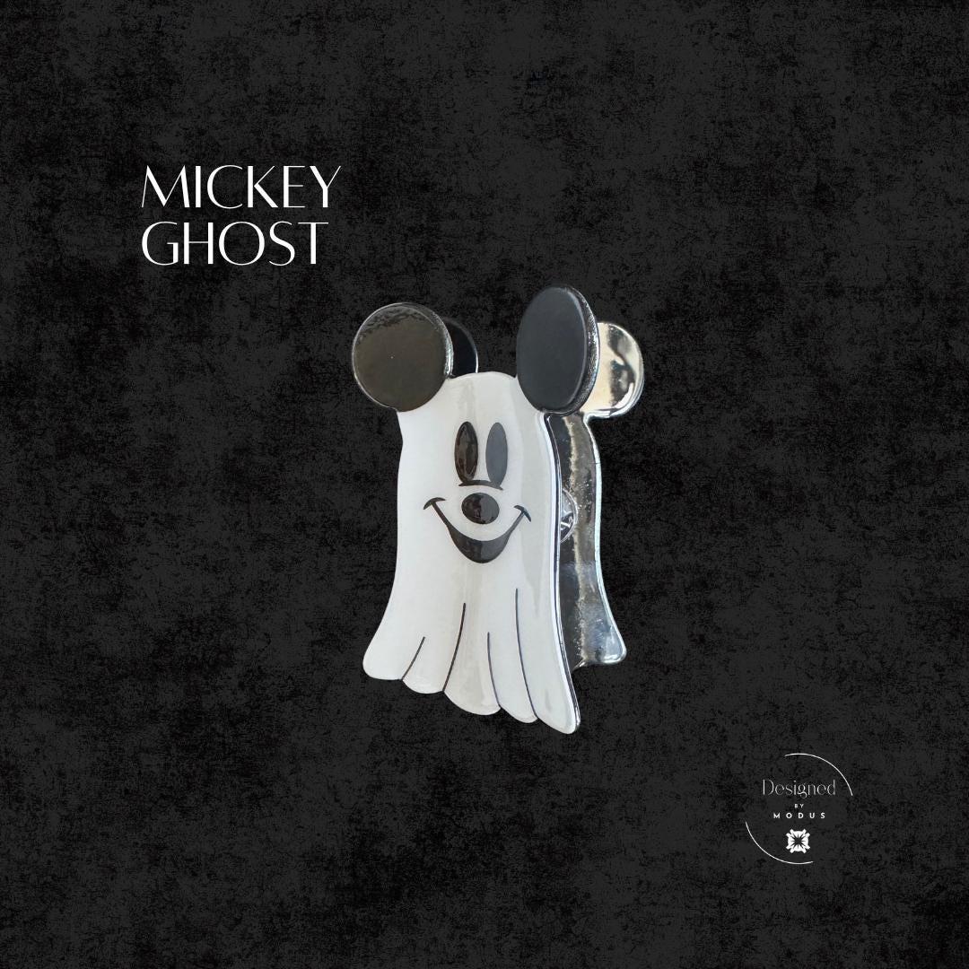 White ghost Mickey hair accessory with black ears, spooky Halloween style.
