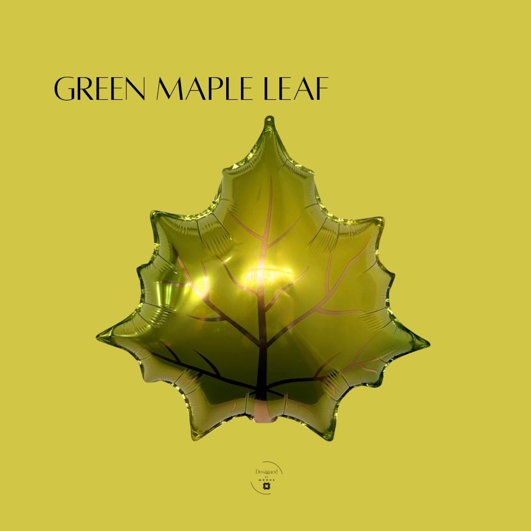 Shiny green maple leaf mylar balloon, perfect for fall parties, Thanksgiving décor, or autumn balloon garlands.