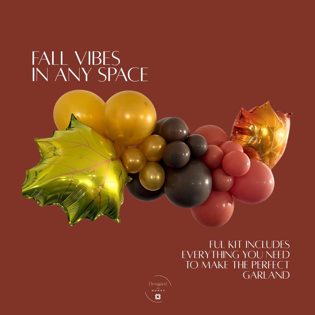 Fall balloon garland kit with gold, burgundy, and black balloons, accented with green and orange maple leaf mylar balloons for Thanksgiving décor.