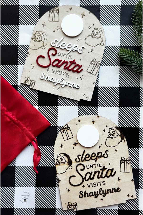 Two personalized Christmas countdown signs side by side, one engraved and one with 3D red lettering, displayed on festive checkered background with red gift bag.