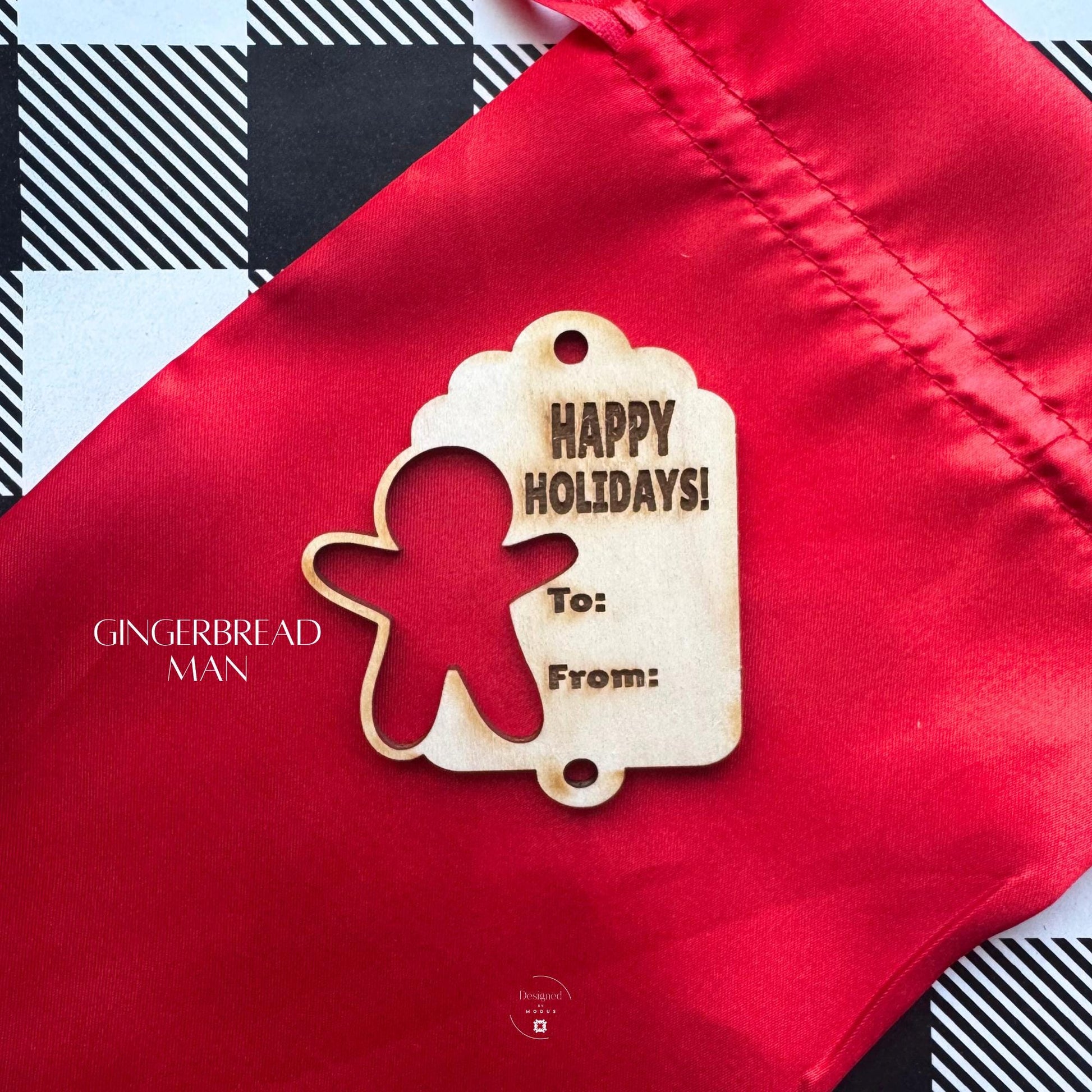 Gingerbread Man laser-cut wooden tag engraved with “Happy Holidays” message, shown on red holiday bag.
