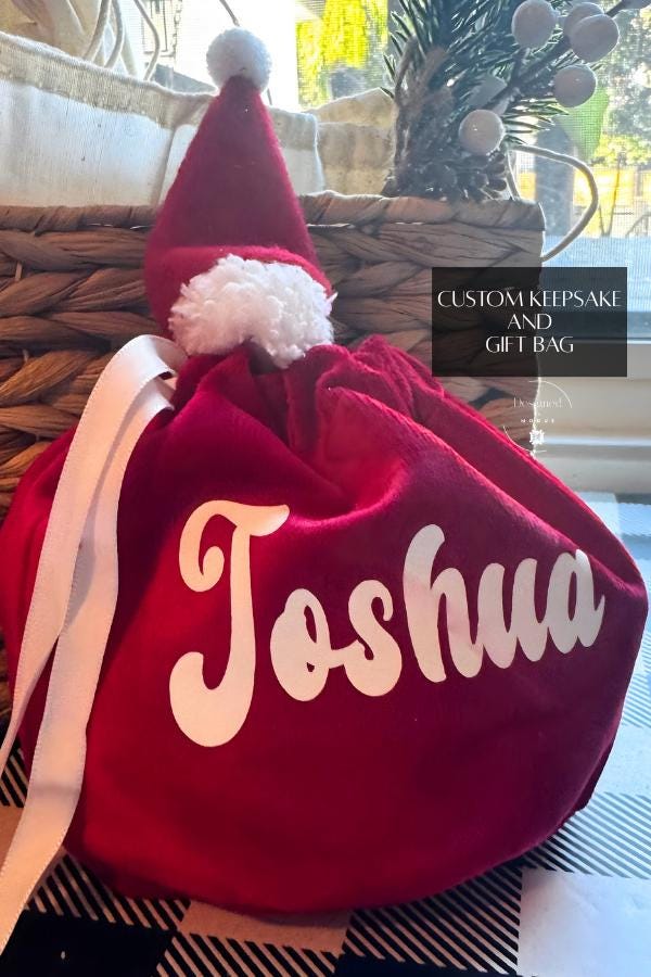 Custom Santa hat Christmas bag with name Joshua, red velvet material, white ribbon, perfect holiday keepsake gift bag.