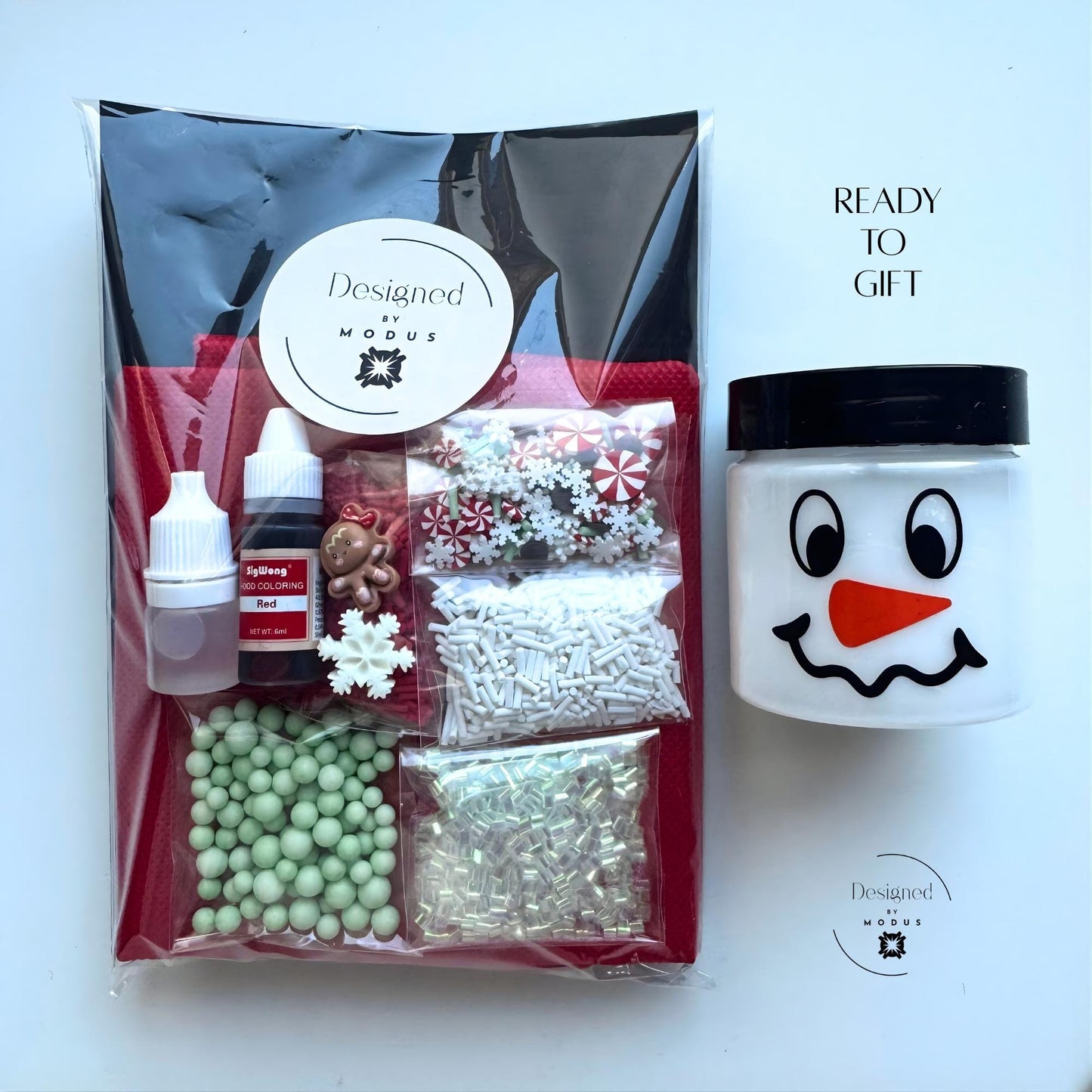 Packaged peppermint slime kit in clear bag with Designed by Modus label and snowman jar, ready to gift for holiday parties or Christmas stocking stuffers.