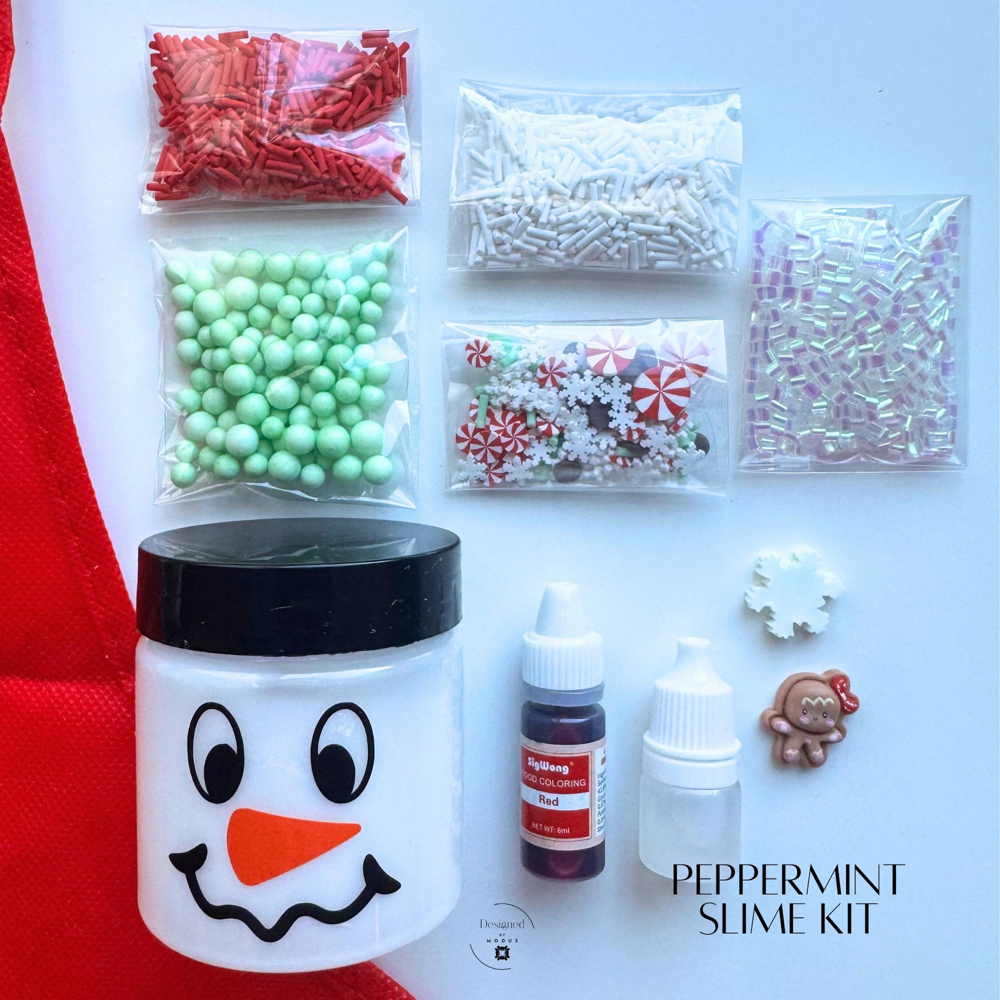 Peppermint slime kit with snowman jar, red and white sprinkles, green foam beads, peppermint charms, and holiday mix-ins for Christmas sensory play.