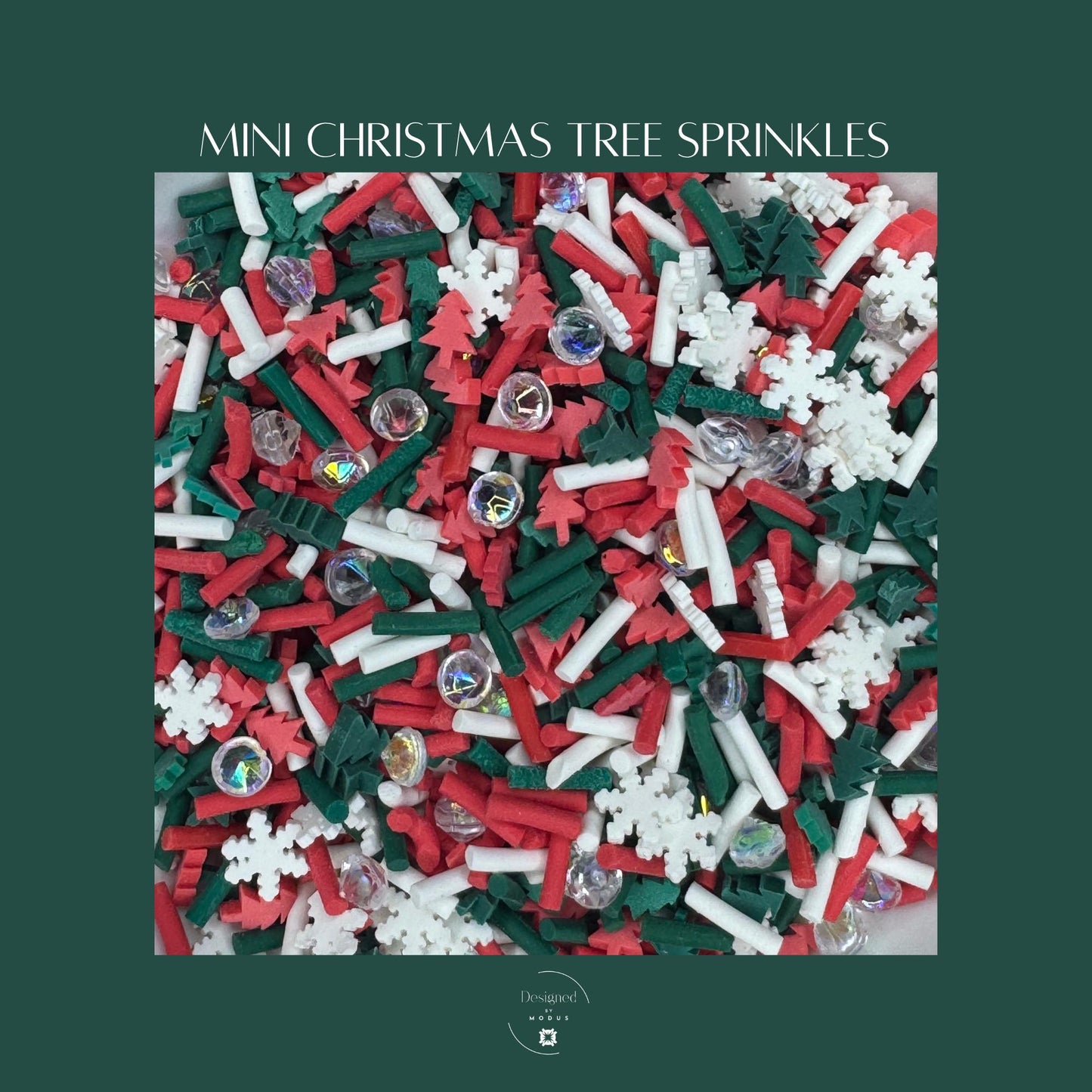 Close-up of mini Christmas tree sprinkles mix featuring red, green, and white polymer shapes, snowflakes, and iridescent faux gems used for holiday slime, crafts, or sensory play.