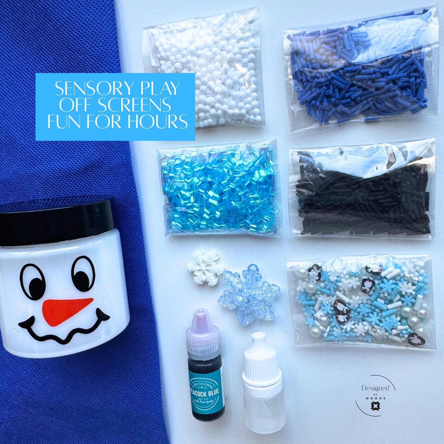Flat lay of Penguin Blue Slime Kit items including pre-made white slime, blue sprinkles, penguin charms, activator, dye, and foam beads with text “Sensory Play Off Screens Fun for Hours.”