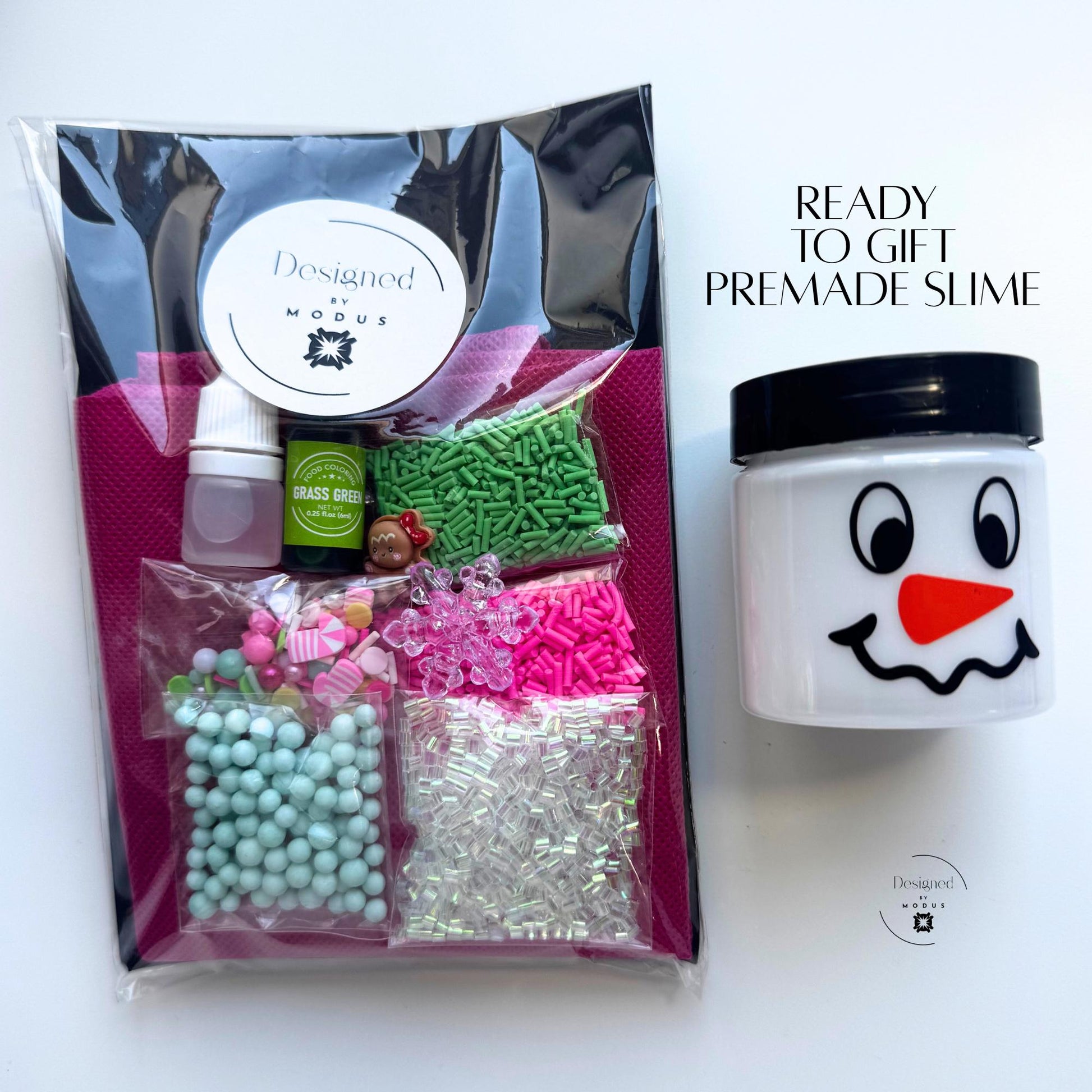 Packaged Pastel Candy Christmas Slime Kit with Designed by Modus label, pink apron, and pastel holiday mix-ins labeled “Ready to Gift Premade Slime.”