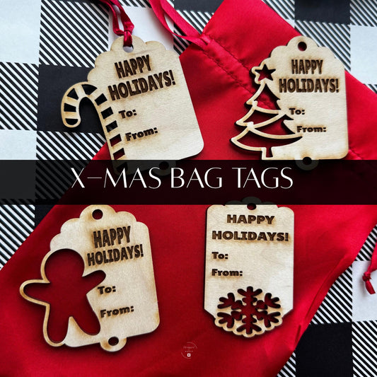 Set of four wooden Christmas gift tags on red bag — Candy Cane, Tree, Gingerbread Man, and Snowflake shapes engraved with “Happy Holidays.”