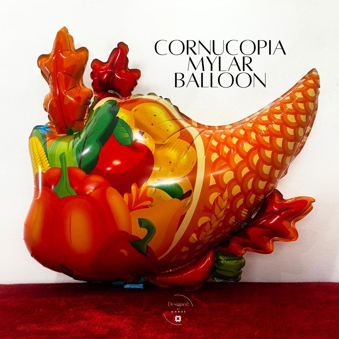 Colorful cornucopia mylar balloon with pumpkins, apples, and fall leaves for Thanksgiving décor.