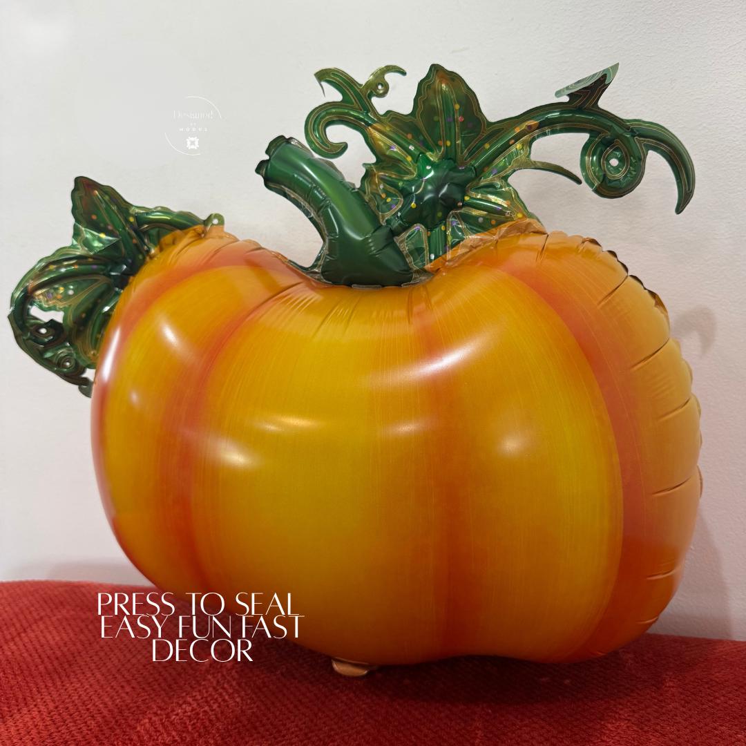 “Pumpkin mylar balloon with green vine details used as easy fall party or office decor.”
