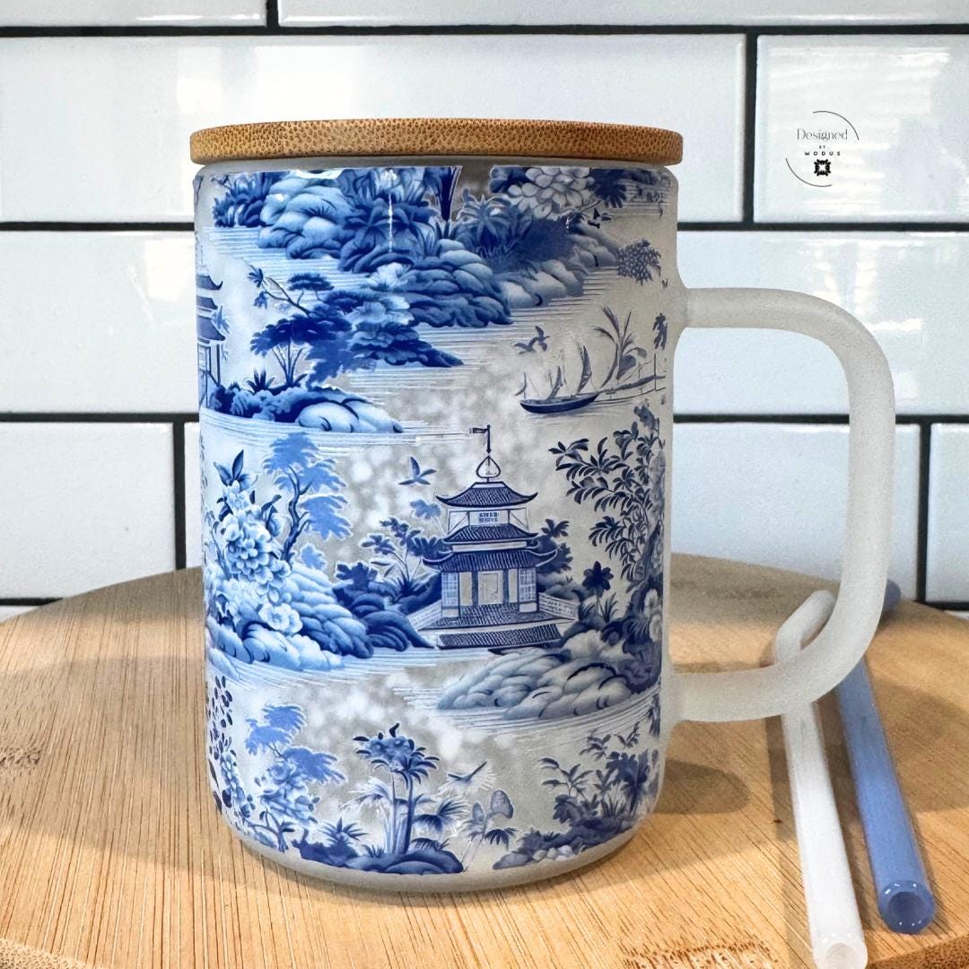 Back view of chinoiserie snowglobe mug featuring intricate floral and pagoda detailing.