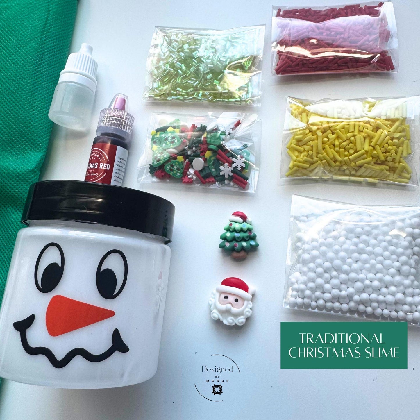 Traditional Christmas Slime kit layout with snowman jar, dye, activator, and colorful red, green, and yellow sprinkles, captioned “Traditional Christmas Slime.”