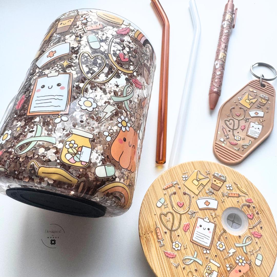 Flat lay of cup, lid, pen, and keychain set on white background.