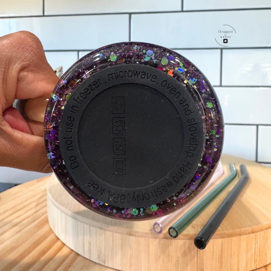 Underside of glitter mug showing BPA-free base and care instructions.