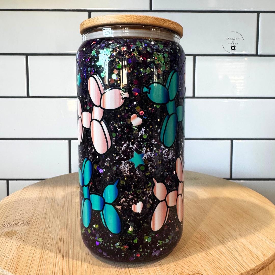 Front view of snowglobe-style mug with handle and sparkling glitter.