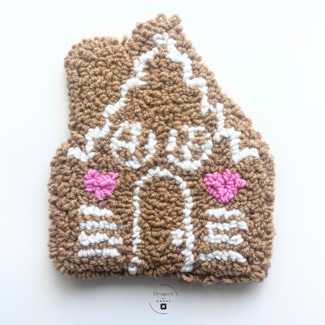 gingerbread house with whit trim and pink window shutters