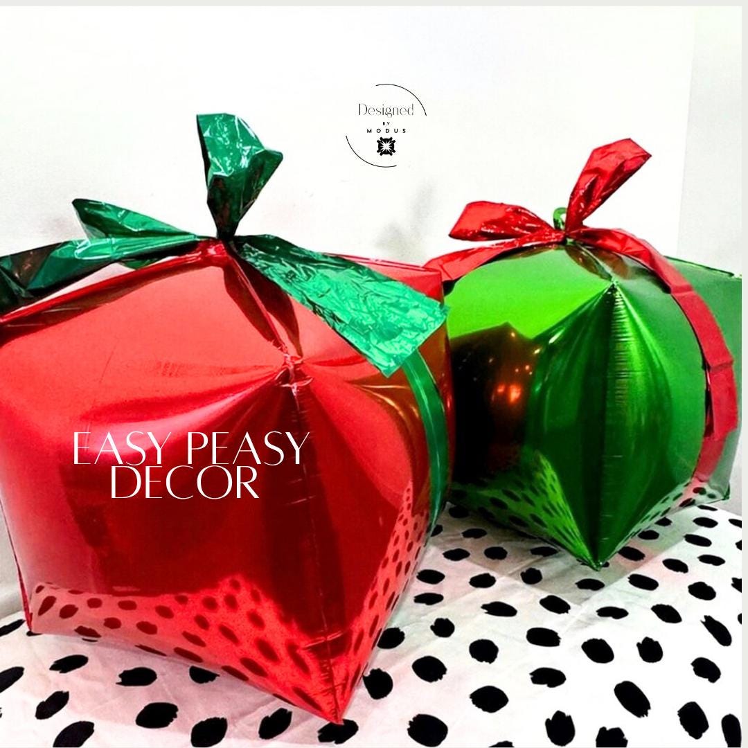 “Pair of holiday gift balloons in red and green showing easy DIY Christmas decor setup.”