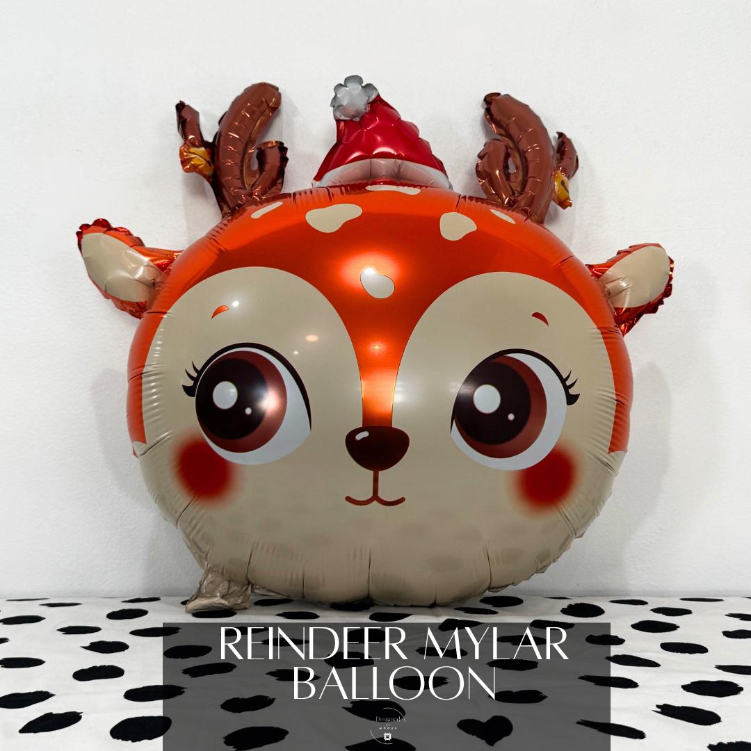 Cute reindeer mylar balloon with antlers and Santa hat for Christmas party decoration.”