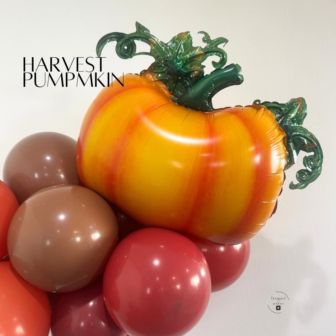 “Harvest pumpkin mylar balloon with green vine details surrounded by brown and orange balloons for fall decor.”
