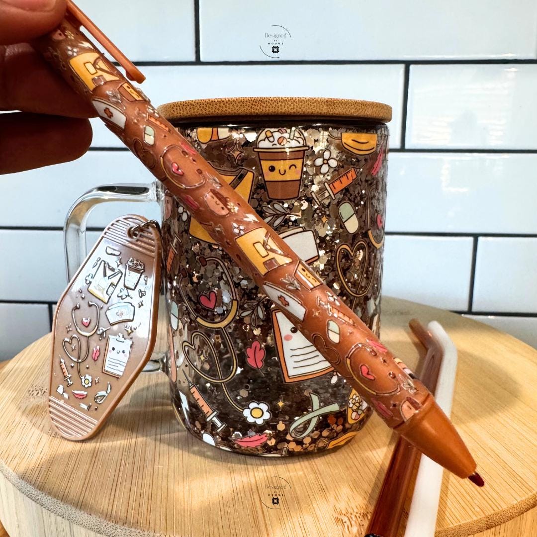 Close-up of matching pen and keychain with nurse motifs.