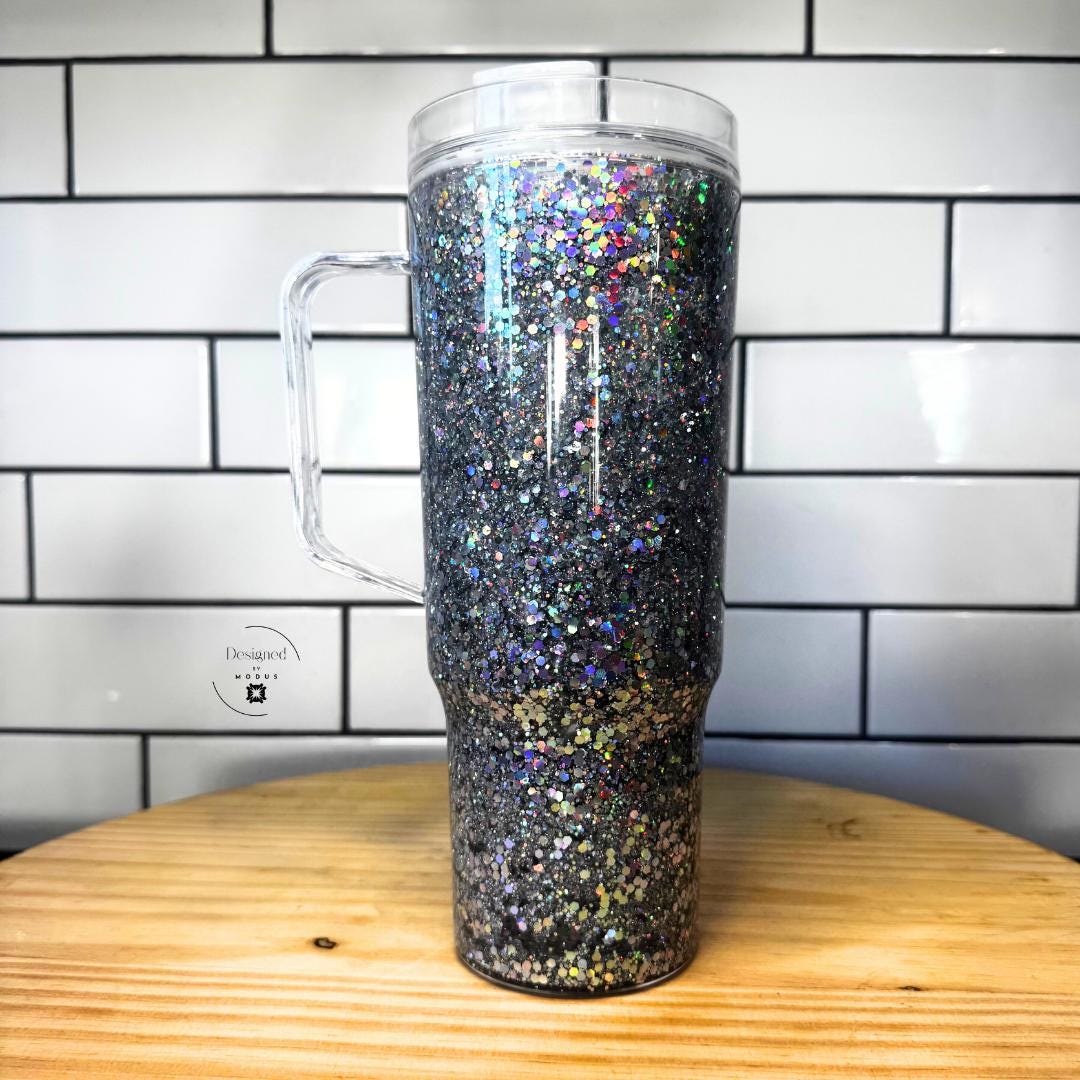 Side view of silver holographic glitter tumbler with clear handle