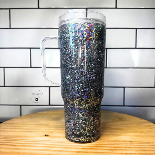 Side view of silver holographic glitter tumbler with clear handle