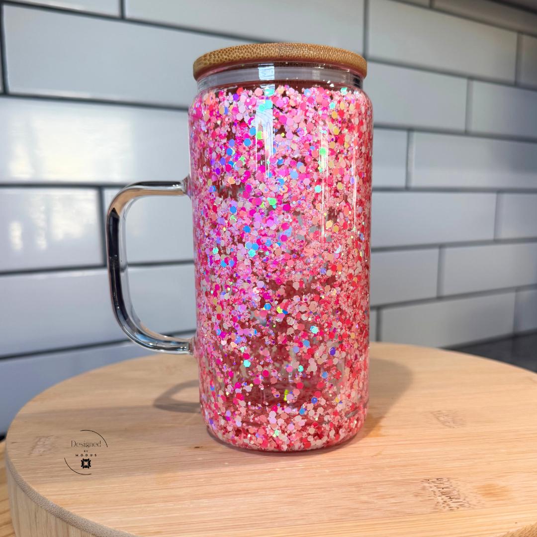 Close-up of pink glitter double wall glass mug with bamboo lid