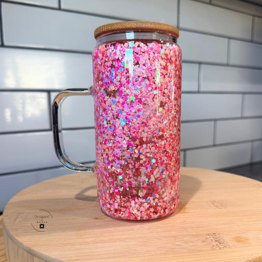 Close-up of pink glitter double wall glass mug with bamboo lid