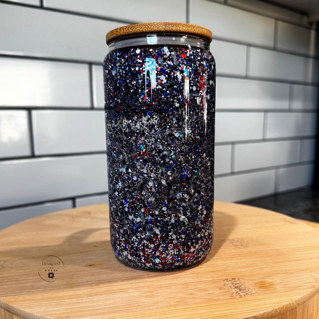 Close-up of navy confetti sparkle drink cup with bamboo lid