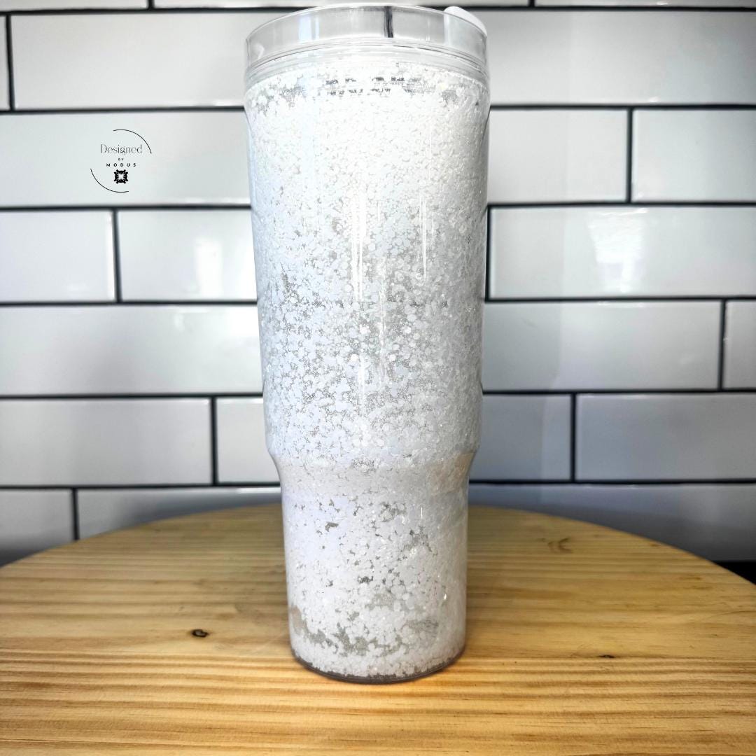 Tall white shimmer tumbler standing upright with sparkling iridescent glitter