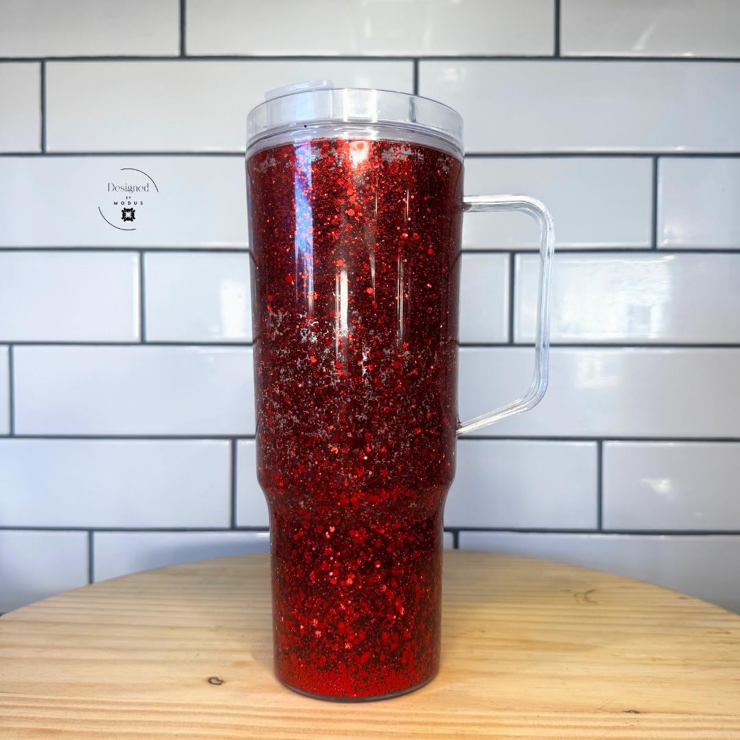 3️⃣ Tall ruby red snow globe cup with floating glitter inside double wall