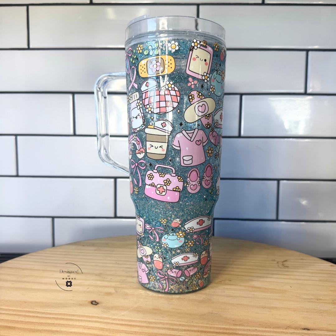 Blue glitter nurse tumbler with handle featuring cute medical icons displayed on wood table.