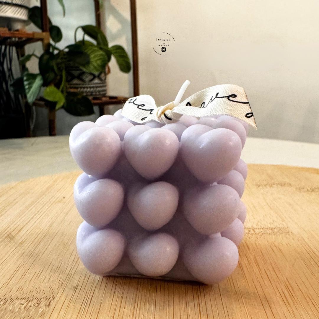 Heart cube candle with stacked heart design in soft pastel color