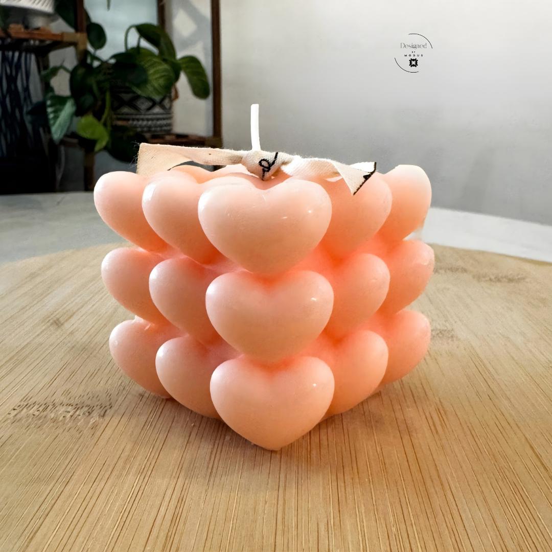 Heart cube candle with stacked heart design in soft pastel color
Close up of heart shaped cube candle decorative texture