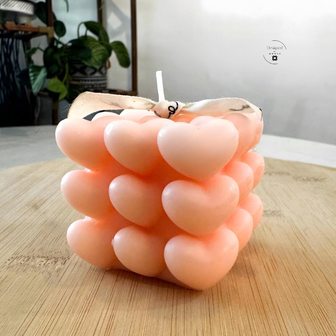 Heart cube candle with stacked heart design in soft pastel color
Close up of heart shaped cube candle decorative texture
Valentine’s Day heart cube candle on wooden surface