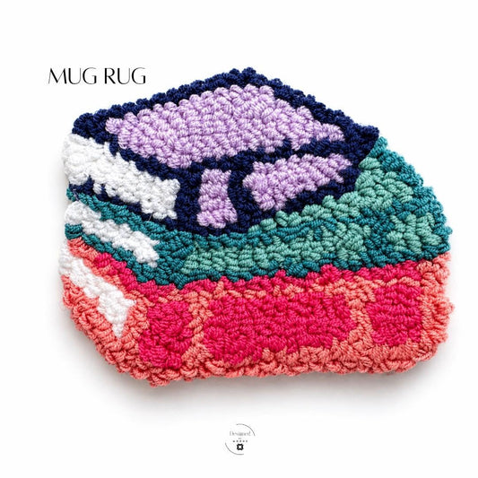 Punch Needle Coaster Handmade Artisan Craft Mug Rug Floral Design Purple Flowers Navy Blue Background Cotton Yarn Construction Plush Textured Surface Teal Coral Pink Border White Accents Coffee Table Styling Kitchen Counter Protection Tea