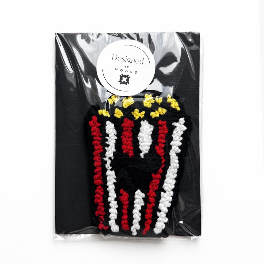 Crochet Popcorn Bucket Coaster Movie Night Essential Coffee Table Protection Handmade Kitchen Accessory Red White Striped Pattern Cinema Theme Gift Yellow Popcorn Design Textured Cotton Yarn Construction Looped Pile Surface Home Theater