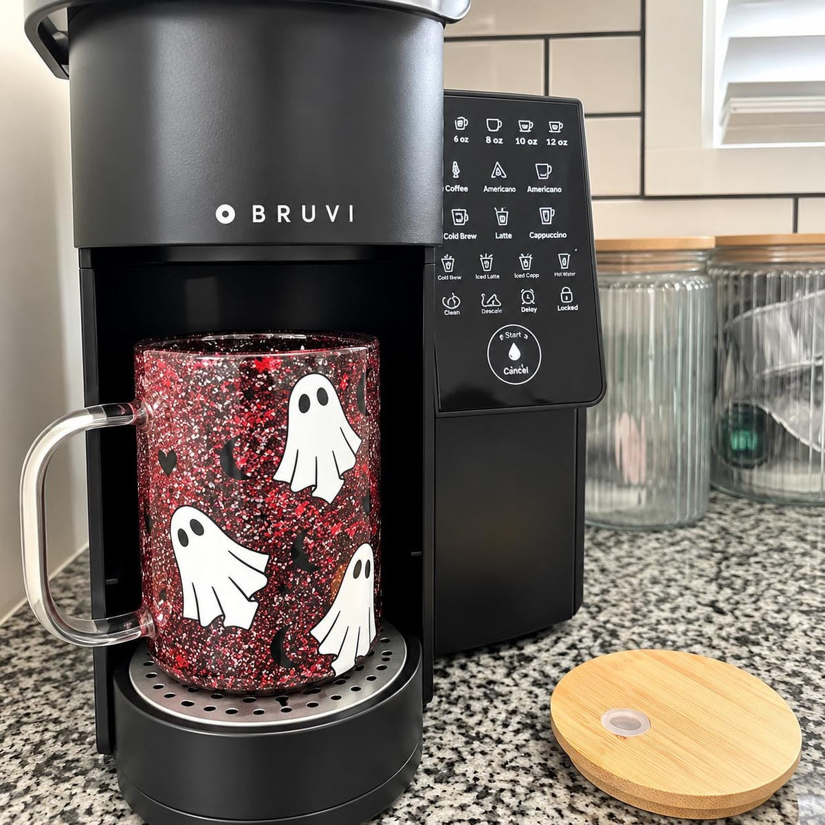Halloween glitter tumbler with white ghost graphic, spooky lettering and floating red and black glitter. This clear snow globe style cup features a bamboo look lid and colorful sparkling Halloween details. Fun ghost tumbler for Halloween lovers, spooky season drinkware, fall party accessories, Halloween gifts and festive cold drink cups.
