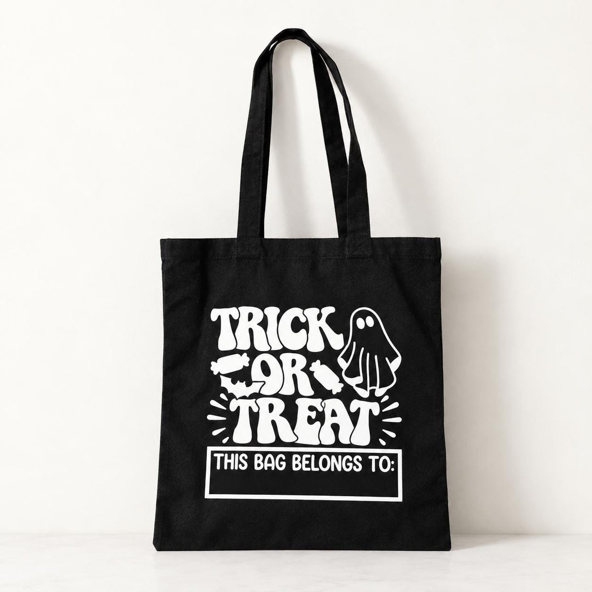 Kids personalized trick or treat tote bag with cute Halloween ghost design and custom name. This reusable cotton Halloween bag gives children their own special candy tote for Halloween night. Great for trick or treating, Halloween parties, school events, fall festivals and trunk or treat celebrations. A fun personalized Halloween gift and custom candy bag for kids.