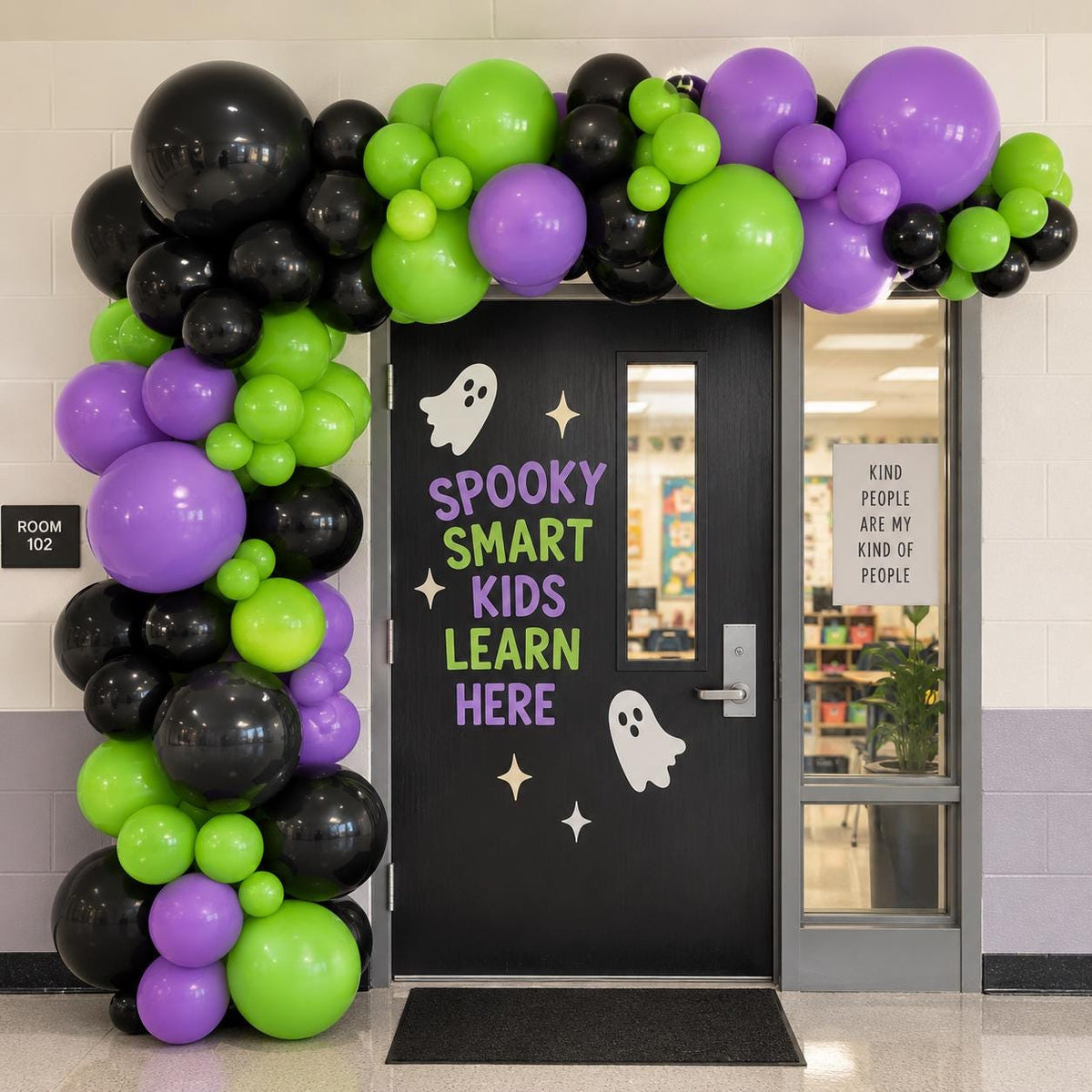 Black lime green and purple Halloween balloon garland decorating a school classroom entrance for spooky season. Lime After Dark features an organic balloon arrangement in multiple sizes for a bold Halloween party backdrop. Great for classroom doors, school Halloween parties, teacher decorations, trunk or treat, kids parties and Halloween events.