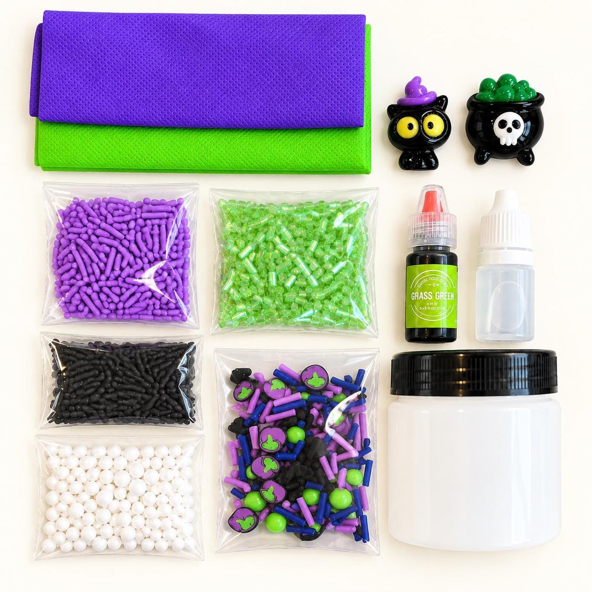 Kids Halloween slime activity kit with premade slime, green dye, Halloween sprinkle mix, witch and black cat charms, apron and slime activator. Custom DIY slime kit designed for Halloween parties, kids birthday parties, classroom celebrations, playdates, sensory activities and party favors. Spooky slime making activity lets children decorate and customize their slime with colorful sprinkles and Halloween charms for hands on creative play.