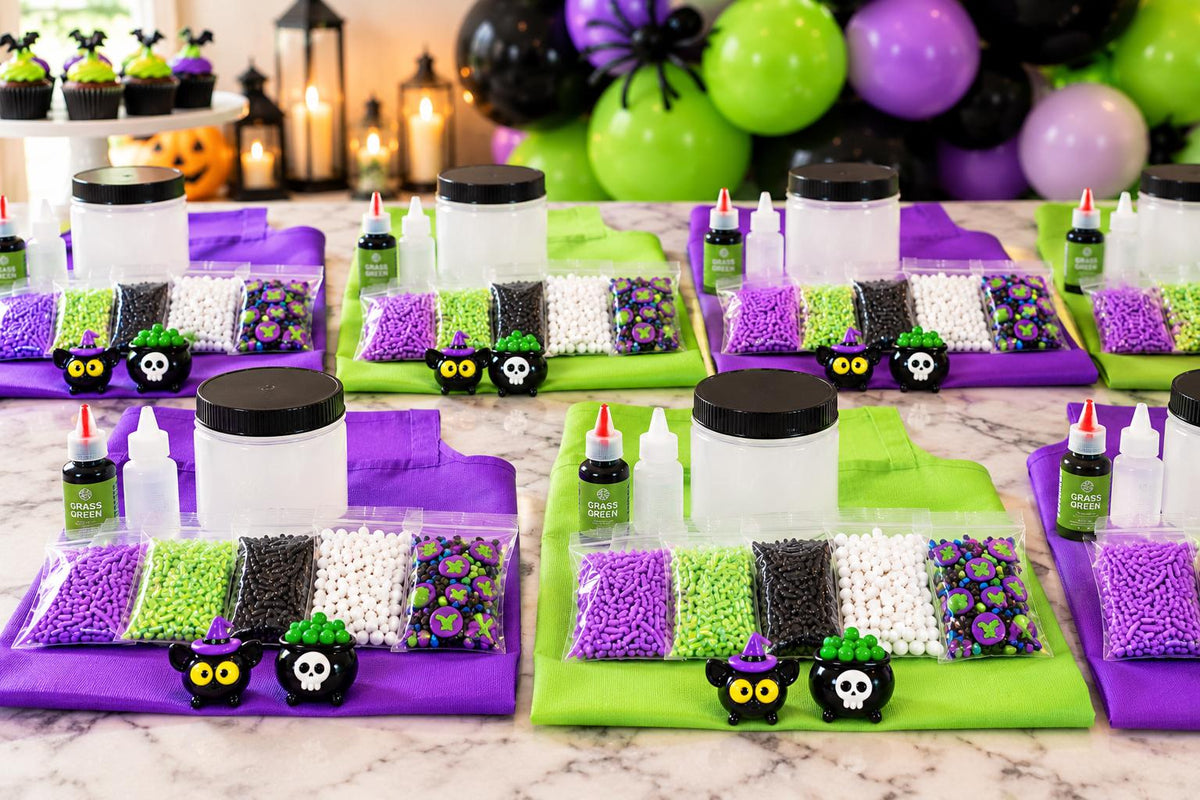 Halloween slime kit for kids featuring premade white slime, green slime dye, Halloween sprinkles, witch and black cat charms, apron and slime activator. Customizable DIY slime making kit for Halloween parties, spooky birthday parties, classroom celebrations, playdates, party favors, sensory activities and kids crafts. Fun Halloween activity for girls and boys, classroom party favor, birthday activity and creative sensory play kit.