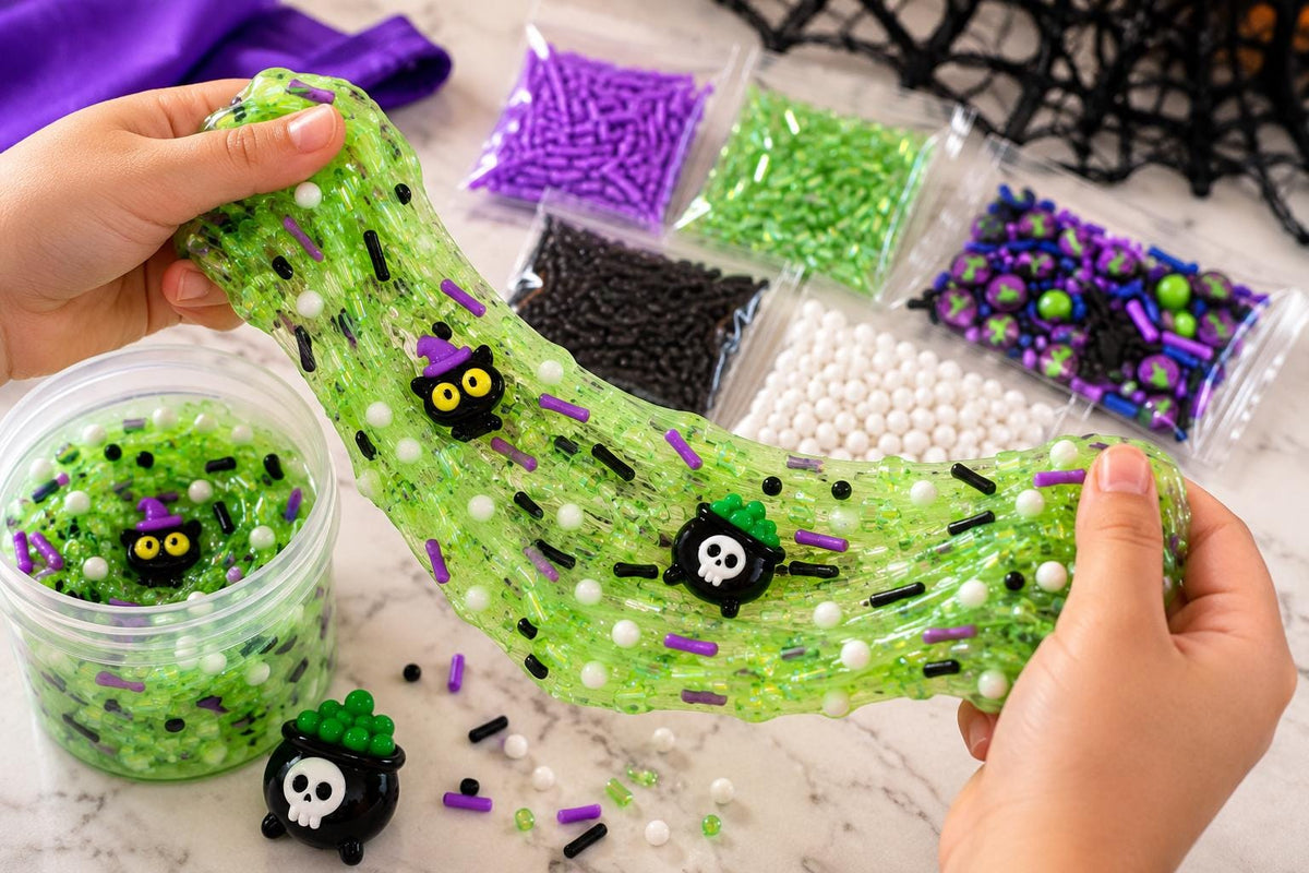 Spooky Halloween slime making kit for kids including premade white slime, green slime dye, Halloween sprinkle decorations, witch and black cat charms, apron and slime activator. Customizable DIY kids slime activity is great for Halloween parties, classroom celebrations, spooky birthday parties, playdates, sensory play and party favors. Fun Halloween craft kit and hands on activity for children who enjoy slime making, decorating and creative sensory play.