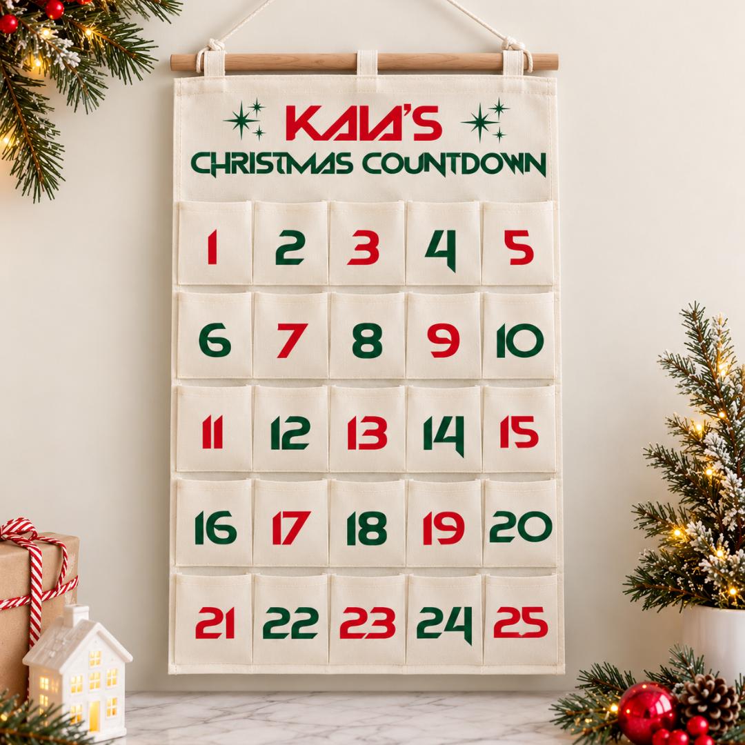 Personalized Christmas advent calendar with 25 fabric pockets, custom child's name and alternating red and green numbers from 1 through 25. Includes 24 colorful miniature squishy toys for daily Christmas countdown surprises. Reusable hanging Christmas calendar with wooden rod for kids ages 5 and older, holiday gifts, personalized Christmas decorations, sensory play activities, Christmas bedroom decor and festive family countdown traditions.