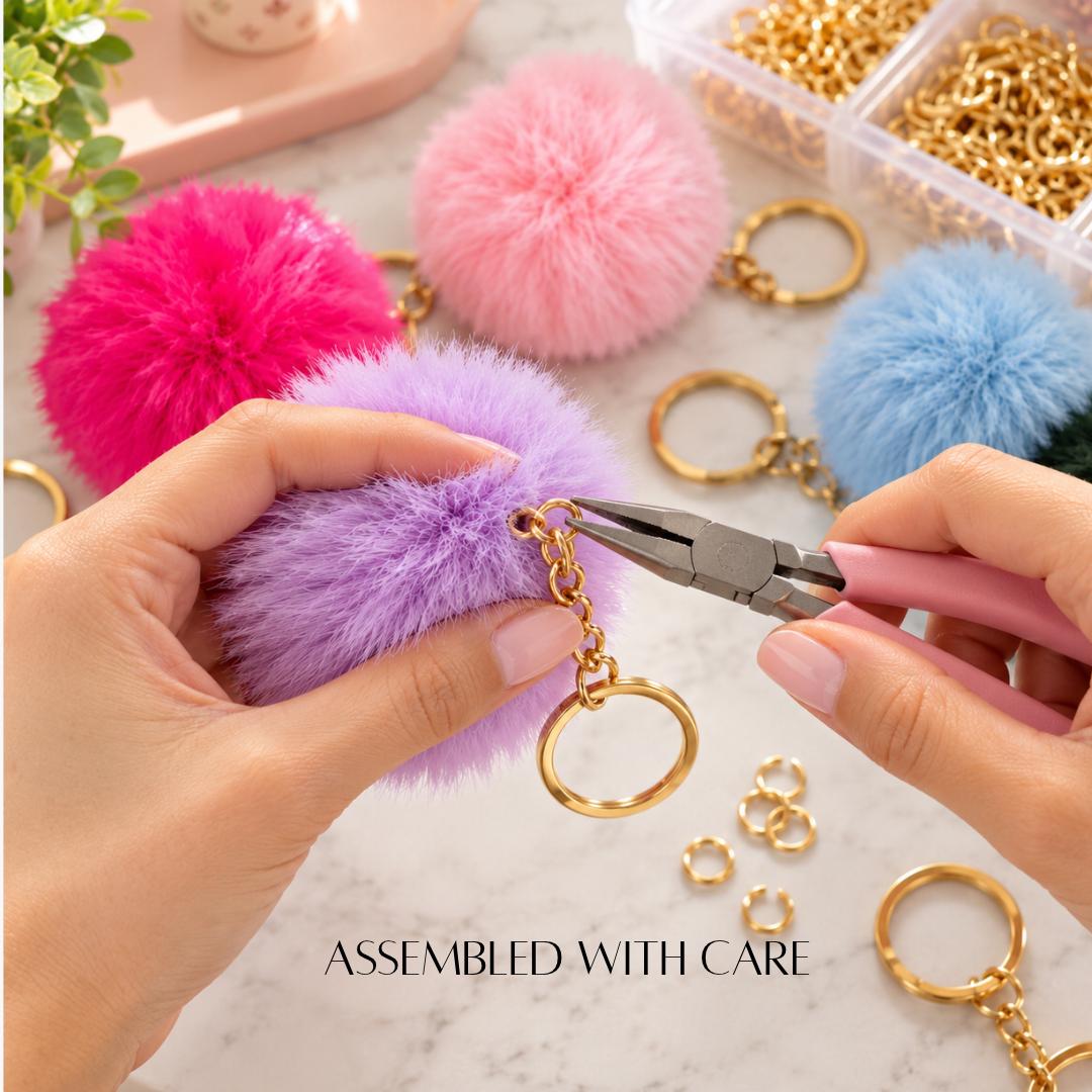 Bright colorful fluffy pom pom bag charms featuring red, blue, orange, yellow, pink and purple pom poms with gold-tone metal key rings. Soft faux fur-style keychain accessories for handbags, backpacks, purses, tote bags and everyday essentials. Fun small gifts for women, teens, teachers, coworkers, friends and Christmas stocking stuffers.